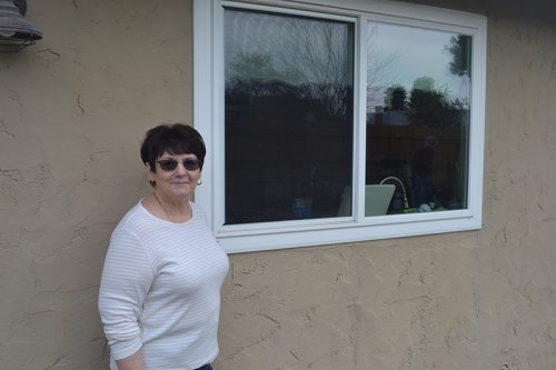Lemoore's Leslie Brixey shows off the energy efficient windows she had installed.